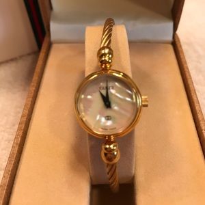 Authentic Gucci mother of pearl gold tone watch